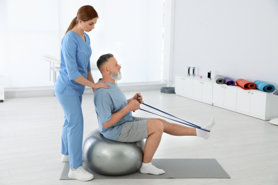 professional physiotherapist working with senior patient in rehabilitation center