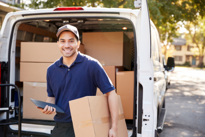 portrait of courier with digital tablet delivering package